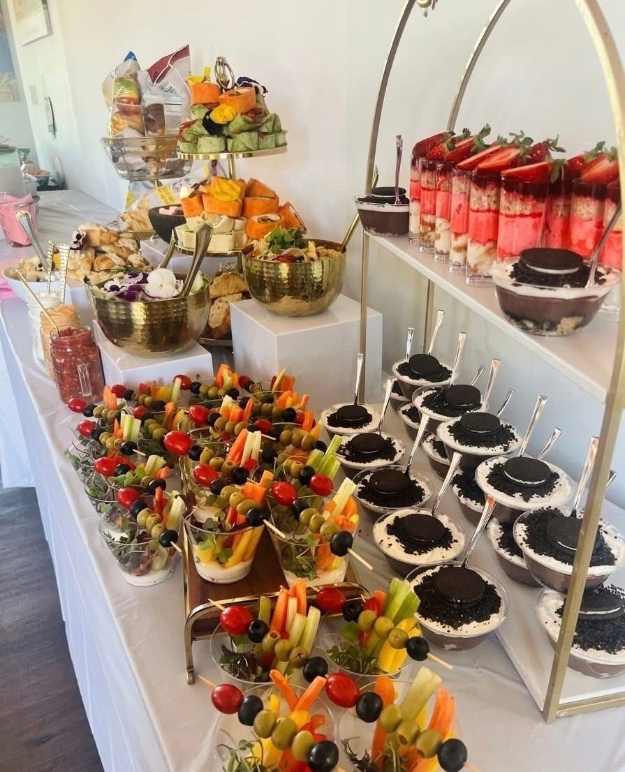 Full event display with veggie cups, dessert shooters, and tiered appetizers