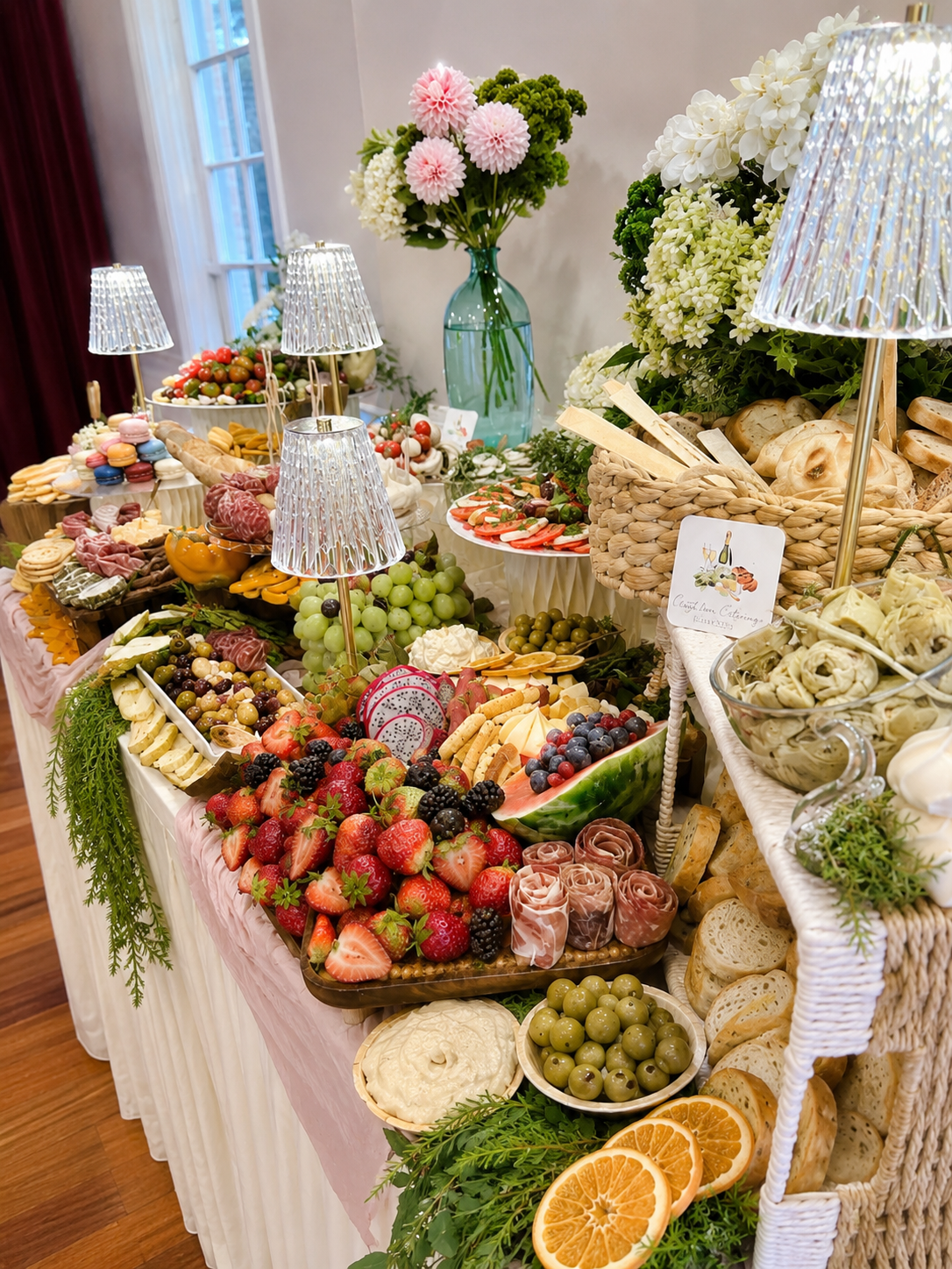 Outdoor evening wedding grazing spread with string lights